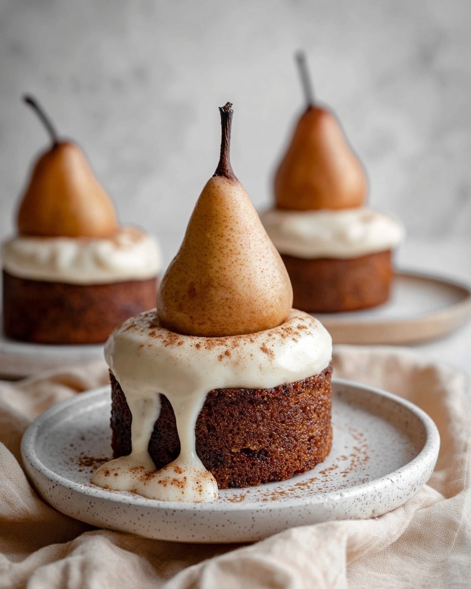 The image shows three desserts, each with three layers. The bottom layer is a dark brown, round cake with a slightly rough texture. On top of the cake, there is a whole light brown pear standing upright with its stem pointing up. The front dessert has a thick, smooth white cream sauce with a slight shine, dripping down the sides of the pear and cake, sprinkled lightly with a brown powder. All desserts are placed on white speckled round plates sitting on a white marbled texture surface with a soft beige cloth around them. Photo taken with an iphone --ar 4:5 --v 7