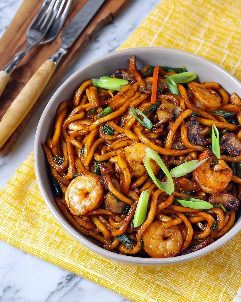 A round white bowl filled with a stir-fry of thick, glossy orange-brown noodles, mixed with plump, cooked shrimp that are light pink with slight char marks, and slices of sautéed mushrooms that are brown and soft. Thin orange carrot sticks and translucent cooked onions are scattered throughout, with bright green sliced scallions sprinkled on top for color contrast. The bowl sits on a yellow and white checkered cloth on a white marbled surface, next to two silver forks with wooden handles. photo taken with an iphone --ar 4:5 --v 7