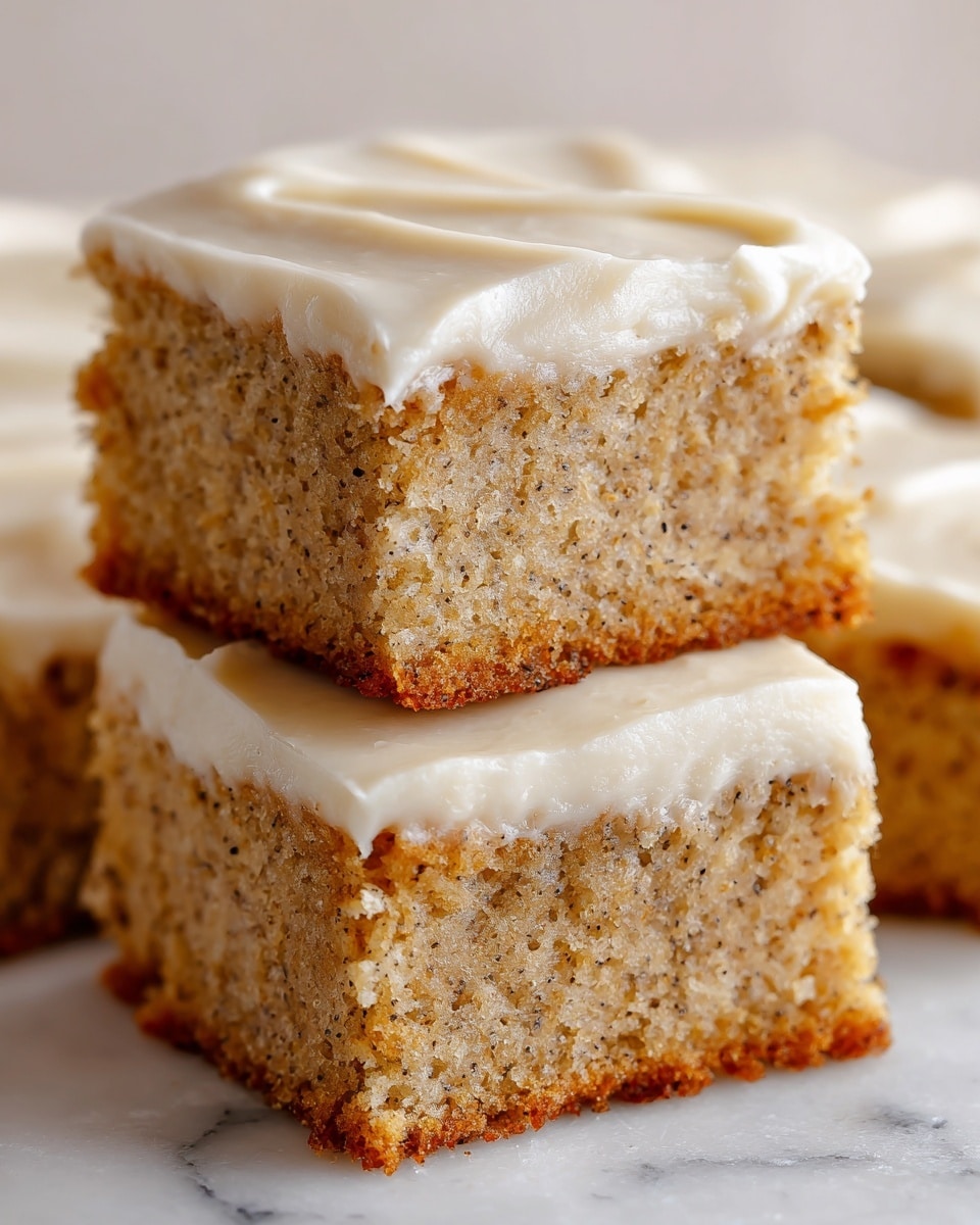 The image shows eight square pieces of cake arranged closely on a round wooden board covered with parchment paper. Each piece has two layers: a thick, moist-looking light brown cake base with visible small darker specks and a smooth, creamy beige frosting layer spread evenly on top, with slight swirls and soft peaks. The background has a soft focus with a neutral, warm tone, and the wooden board contrasts gently with the white marbled texture surface beneath it. photo taken with an iphone --ar 4:5 --v 7