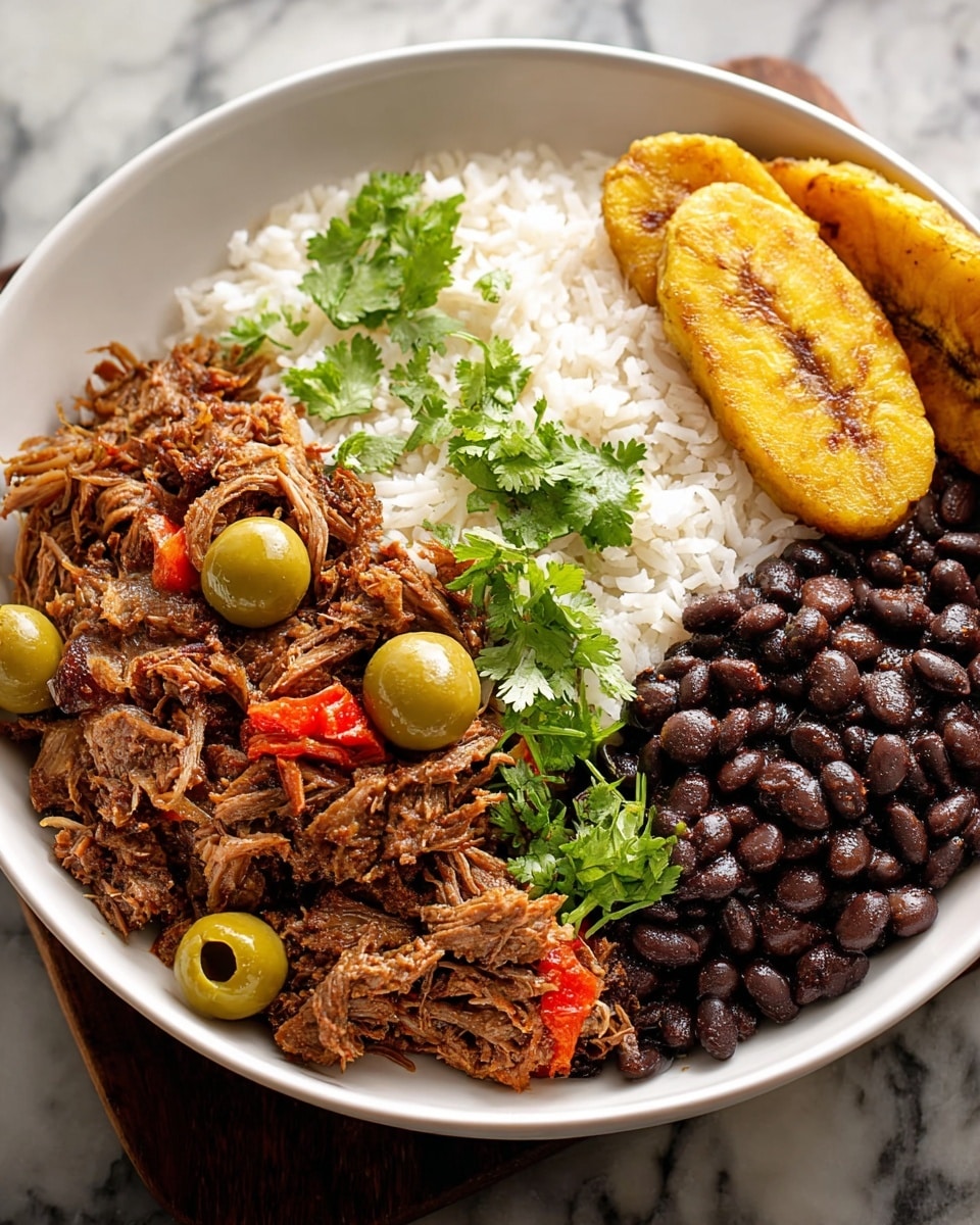 A white round bowl shows four main layers arranged side by side: at the back left is a fluffy layer of white rice with a few green cilantro leaves on top; in the front left is shredded brown meat mixed with whole green olives and pieces of red pepper, garnished with bright green cilantro leaves; to the right of the meat is a dark black bean pile with a shiny texture; on the far right are two golden-brown fried plantains with a slightly crispy surface. The bowl is placed on a white marbled texture surface. Photo taken with an iphone --ar 4:5 --v 7
