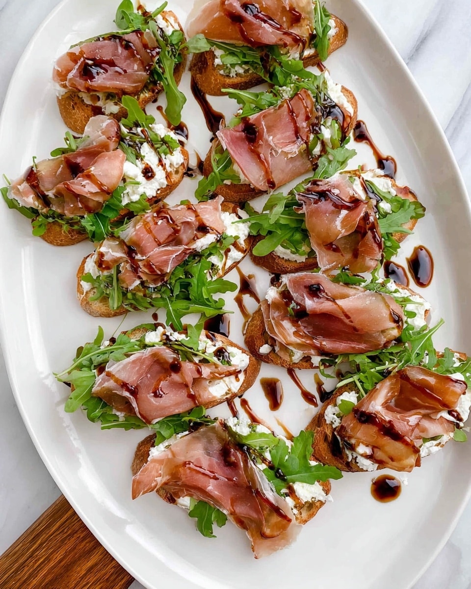 The image shows a white plate with a wooden handle, placed on a white marbled texture. There are nine pieces of toasted bread arranged on the plate. Each piece has three layers: the first layer is creamy white spread, the second layer is bright green leafy arugula, and the third layer is thin, pink slices of prosciutto folded loosely on top. A dark brown balsamic glaze is drizzled over the top of each piece and the plate, adding a glossy texture and contrast to the colors. photo taken with an iphone --ar 4:5 --v 7