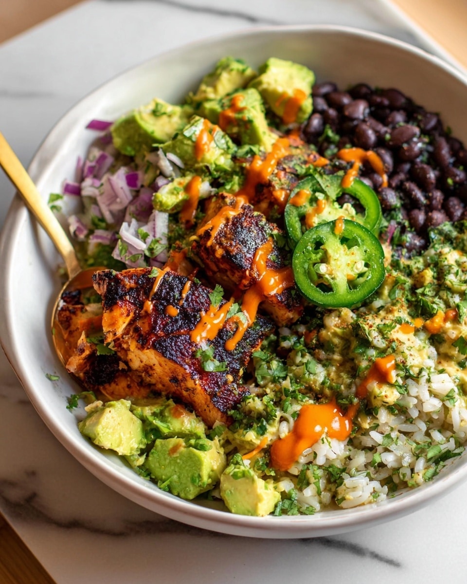 The dish is served in a white bowl filled with four main sections: on the left side, there is a pile of black beans with a smooth texture and deep black color, topped with chunks of light green avocado mixed with small pieces of red onion and cilantro; next to the beans, there are two pieces of grilled chicken with a dark, charred surface, glistening with an orange drizzle of sauce; on the right side, there is a portion of white rice mixed with herbs and small bits of green cilantro, with three bright green slices of jalapeño resting on top; the entire dish is garnished with more of the orange sauce drizzled unevenly across the chicken, avocado, and rice, creating a vibrant contrast against the fresh ingredients. A gold spoon rests inside the bowl on the right edge, and the background shows a white marbled textured surface. photo taken with an iphone --ar 4:5 --v 7