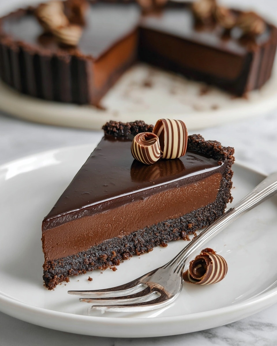 The image shows a single slice of dark chocolate tart on a white plate with a shiny metal fork beside it. The tart has three distinct layers: a crumbly dark brown crust at the bottom, a thick middle layer of smooth matte dark chocolate filling, and a glossy dark chocolate ganache on top. There are two small chocolate curls with light and dark brown stripes placed on the ganache layer, and one more chocolate curl sits on the plate close to the tart slice. In the background, the rest of the tart is visible on a white marbled surface, cut into similar slices. The lighting highlights the glossy texture of the chocolate ganache, giving the dessert a rich and creamy look. Photo taken with an iphone --ar 4:5 --v 7